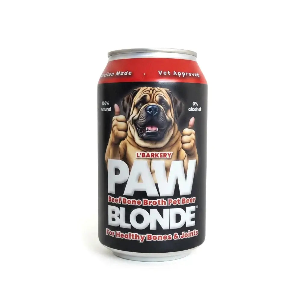 A 16 oz aluminum can of L'Barkery PAW BLONDE Beef Bone Broth Pet Beer, featuring a black label with a graphic of a brown dog giving two thumbs up, on a white background.